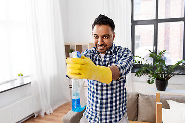 Image showing smiling indian man with detergent cleaning at home