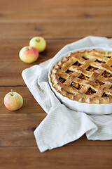 Image showing close up of apple pie in baking mold on towel