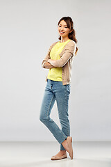 Image showing happy asian woman over grey background