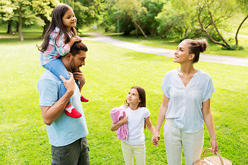 Image showing happy family with picnic basket in summer park