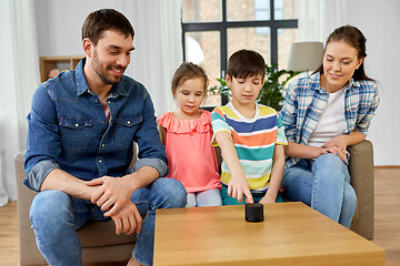 Image showing happy family with smart speaker at home