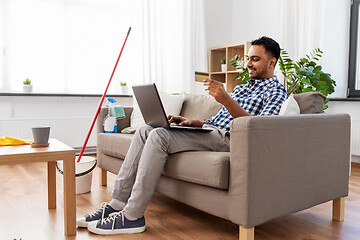 Image showing man with laptop shopping online after cleaning