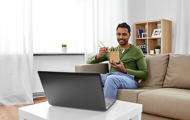 Image showing indian man with laptop eating takeout food at home