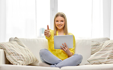 Image showing young woman with tablet pc showing thumbs up