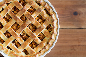 Image showing close up of apple pie in mold on wooden table