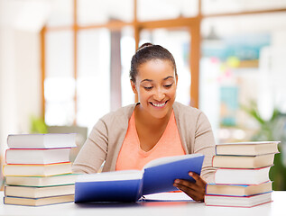 Image showing african american female student reading book