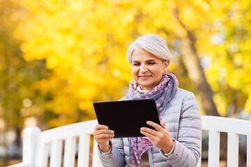 Image showing senior woman with tablet pc at summer park