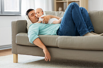 Image showing father with baby sleeping on sofa at home