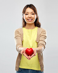 Image showing happy asian woman holding red heart