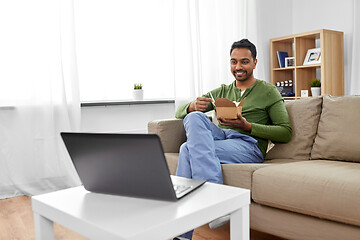 Image showing indian man with laptop eating takeout food at home