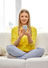 Image showing young woman or teen girl with smartphone at home