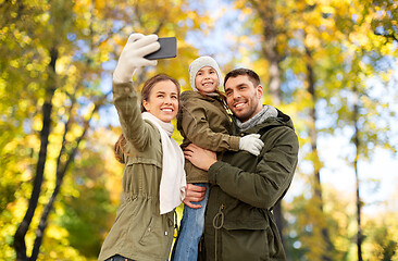 Image showing family taking selfie by smartphone in autumn park