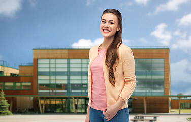 Image showing smiling young student woman over school background