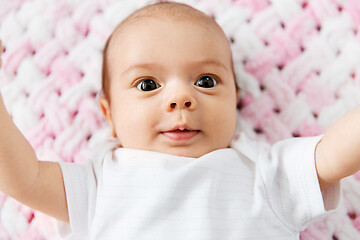 Image showing sweet baby girl lying on knitted plush blanket