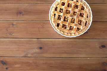 Image showing close up of apple pie in mold on wooden table