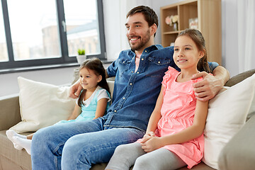 Image showing happy father with daughters on sofa at home