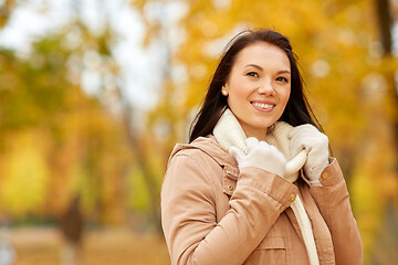 Image showing beautiful happy young woman smiling in autumn park
