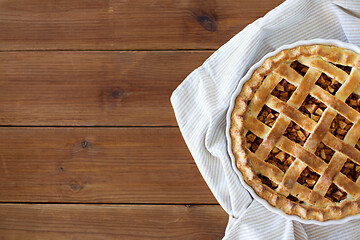 Image showing close up of apple pie in mold on wooden table