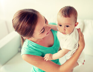 Image showing happy young mother with little baby at home