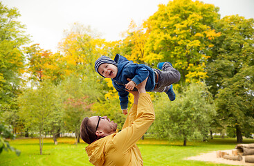 Image showing father with son playing and having fun in autumn