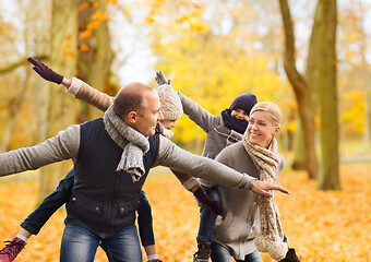 Image showing happy family having fun in autumn park