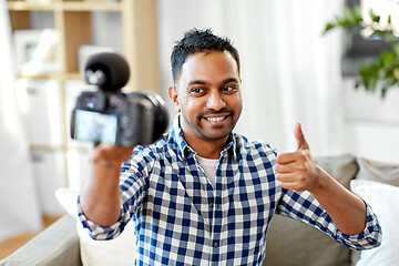 Image showing male video blogger with camera blogging at home