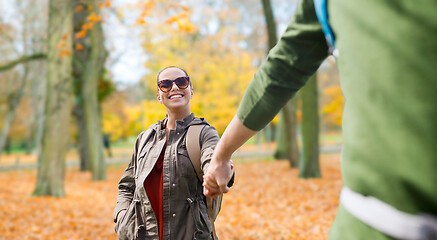 Image showing happy couple with backpacks hiking outdoors