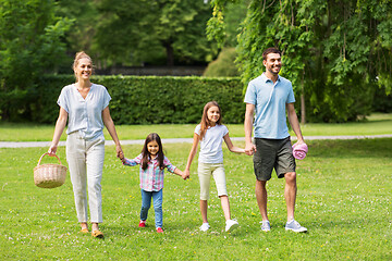 Image showing family with picnic basket walking in summer park