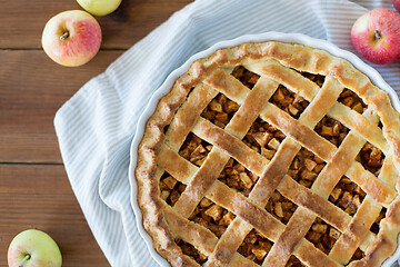 Image showing apple pie in baking mold on wooden table