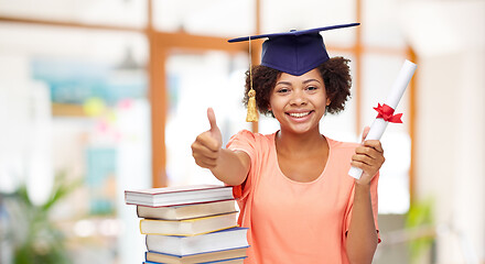 Image showing african graduate student with books and diploma