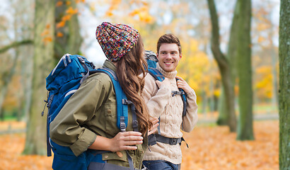 Image showing smiling couple with backpacks hiking in autumn