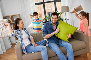 Image showing happy family having pillow fight at home