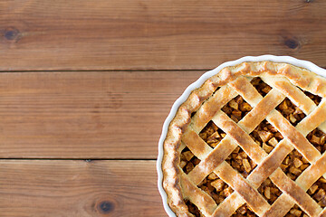 Image showing close up of apple pie in mold on wooden table