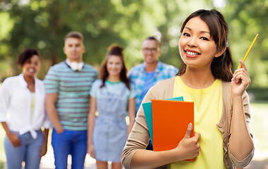 Image showing asian student woman with books and pencil