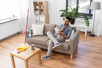 Image showing indian man with to do list after home cleaning