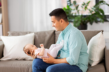 Image showing middle aged father with baby daughter at home