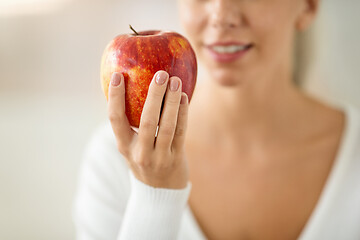 Image showing close up of woman holding ripe red apple