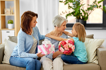 Image showing granddaughter hugging and greeting grandmother