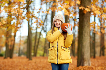 Image showing happy girl with pumpkin at autumn park