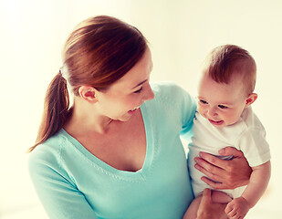 Image showing happy young mother with little baby at home