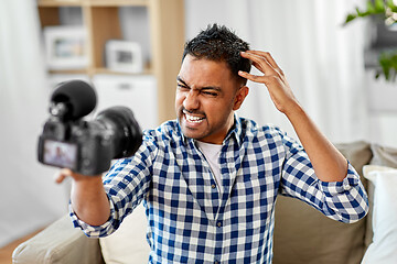 Image showing male video blogger with camera blogging at home