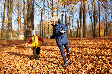 Image showing happy children running at autumn park