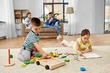 Image showing brother and sister playing and drawing at home