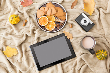 Image showing tablet computer, hot chocolate and autumn leaves