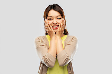 Image showing happy amazed asian woman over grey background