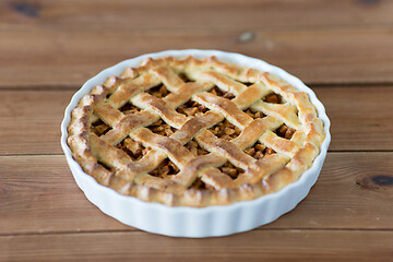 Image showing apple pie in baking mold on wooden table