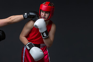 Image showing young boxer is being punched