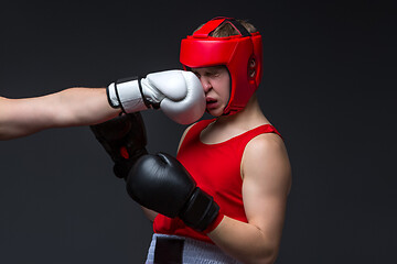 Image showing young boxer is being punched