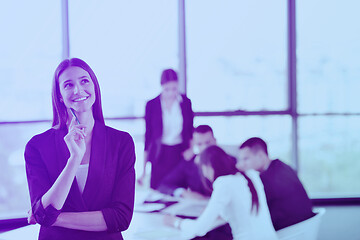 Image showing business woman with her staff in background at office