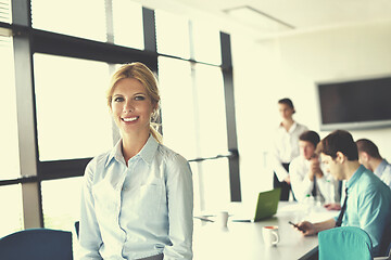 Image showing business woman with her staff in background at office